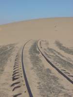 Die Namib-Wste wie sie lebt! Die Wstenbahn wie sie ist! Die Sdbahnstrecke nach Lderitz verschwindet unter einer Wanderdne.